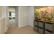 Upstairs hallway with neutral carpet, wall decorations, and open doors to interior rooms at 4960 Jatoba Rd, Acworth, GA 30101
