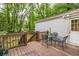 Outdoor seating on a wooden back deck that includes a table and chairs looking out into the spacious, grassy yard at 1866 Tiger Flowers Nw Dr, Atlanta, GA 30314