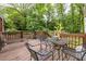 Back deck with table, chairs and a view of the wooded yard at 1866 Tiger Flowers Nw Dr, Atlanta, GA 30314