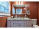 Bathroom featuring granite counters, white cabinets, vanity and bronze walls at 1866 Tiger Flowers Nw Dr, Atlanta, GA 30314