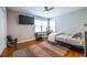 Cozy bedroom with natural light, hardwood floors and TV at 1866 Tiger Flowers Nw Dr, Atlanta, GA 30314