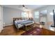 Spacious bedroom with hardwood floors, ceiling fan, natural light, and a cozy rug at 1866 Tiger Flowers Nw Dr, Atlanta, GA 30314