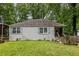 Charming one-story home with a well-maintained lawn and light blue shutters at 1866 Tiger Flowers Nw Dr, Atlanta, GA 30314