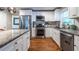 Modern kitchen with stainless steel appliances, granite countertops, and white cabinetry at 1866 Tiger Flowers Nw Dr, Atlanta, GA 30314