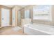 Bathroom features a walk-in shower, soaking tub, and natural light at 2625 Blackstock Dr, Cumming, GA 30041