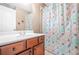 Bathroom with vanity, mirror, and bathtub featuring a seashell patterned shower curtain at 2625 Blackstock Dr, Cumming, GA 30041