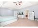 Spacious bedroom featuring a tray ceiling with ceiling fan and white dressers at 2625 Blackstock Dr, Cumming, GA 30041
