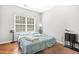 Bedroom with hardwood flooring, a window, and blue accents at 2625 Blackstock Dr, Cumming, GA 30041