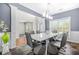 An elegant dining room boasting modern lighting and stylish gray chairs surrounding a glossy white table at 2625 Blackstock Dr, Cumming, GA 30041