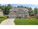 Charming two-story home with gray siding, stone accents, and a well-manicured lawn at 2625 Blackstock Dr, Cumming, GA 30041