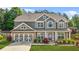 Charming two-story home with gray siding, stone accents, and a well-manicured lawn at 2625 Blackstock Dr, Cumming, GA 30041