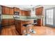 The kitchen features wood cabinets, granite countertops, stainless appliances, and a breakfast bar with seating at 2625 Blackstock Dr, Cumming, GA 30041