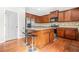 Well-equipped kitchen featuring wood cabinets, granite countertops, stainless appliances, and a breakfast bar at 2625 Blackstock Dr, Cumming, GA 30041