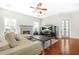 A bright living room with hardwood floors, fireplace, ceiling fan, and comfortable seating at 2625 Blackstock Dr, Cumming, GA 30041