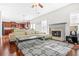 The living room and kitchen flow together seamlessly, with a fireplace, hardwood floors, and natural light at 2625 Blackstock Dr, Cumming, GA 30041