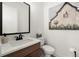 Cozy powder room featuring a vanity, toilet, and decorative painting at 326 Treble Way, Alpharetta, GA 30009