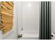 Tiled bathtub with a shower curtain, complemented by a natural wood decoration at 326 Treble Way, Alpharetta, GA 30009