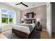 Stylish bedroom with a black ceiling fan and eye-catching striped accent wall and natural lighting at 326 Treble Way, Alpharetta, GA 30009