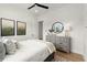 Bright bedroom with natural light, a neatly styled dresser, and minimalist decor at 326 Treble Way, Alpharetta, GA 30009