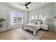 Bright bedroom featuring a board and batten accent wall, stylish furnishings, and a large window with scenic views at 326 Treble Way, Alpharetta, GA 30009