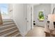 Welcoming entryway with hardwood floors, staircase, closet, and a view of the outdoors through the front door at 326 Treble Way, Alpharetta, GA 30009