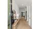 Bright hallway with light wood floors, a stylish console table, and views into other living spaces at 326 Treble Way, Alpharetta, GA 30009
