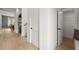 Hallway with hardwood floors and white walls, leading to additional rooms and closet space at 326 Treble Way, Alpharetta, GA 30009