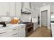 Bright kitchen with white cabinets, stainless steel appliances, subway tile backsplash, and hardwood flooring at 326 Treble Way, Alpharetta, GA 30009