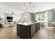 Open concept kitchen with an island, stainless steel appliances, hardwood floors, and eat in dining area at 326 Treble Way, Alpharetta, GA 30009