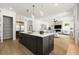Beautiful kitchen featuring an island with white countertop, stainless steel appliances, and modern pendant lighting at 326 Treble Way, Alpharetta, GA 30009