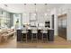 Open kitchen featuring a large island with seating, stainless steel appliances, and wood floors at 326 Treble Way, Alpharetta, GA 30009
