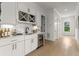Modern kitchenette with white cabinets, wine storage, undermount sink, and beverage cooler enhances entertainment options at 326 Treble Way, Alpharetta, GA 30009