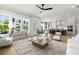 Open concept living room, kitchen, and dining area with ample natural light, hardwood floors, and modern finishes at 326 Treble Way, Alpharetta, GA 30009