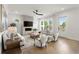 Bright living room featuring a modern fireplace, hardwood floors, comfortable seating, and plenty of natural light at 326 Treble Way, Alpharetta, GA 30009