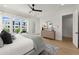 Bright main bedroom with large windows, modern dresser, and hardwood floors at 326 Treble Way, Alpharetta, GA 30009