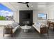 Inviting outdoor lounge with comfortable seating, a fireplace, a mounted television, and scenic neighborhood views at 326 Treble Way, Alpharetta, GA 30009