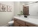 Modern bathroom features wood cabinets, white countertops, and stylish floral wall art at 435 Mezzo Ln # 86, Alpharetta, GA 30009