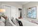 Comfortable bedroom featuring plush pillows, art on wall, and white sliding closet doors at 435 Mezzo Ln # 86, Alpharetta, GA 30009