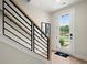 Welcoming entryway boasts modern railing, light hardwood floors, and a bright, airy feel at 435 Mezzo Ln # 86, Alpharetta, GA 30009