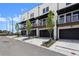 Modern townhomes offer stylish living with balconies and garage entrances, under a clear blue sky at 435 Mezzo Ln # 86, Alpharetta, GA 30009