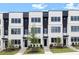Modern townhome exterior showcasing white brick, black accents, large windows, and professional landscaping at 435 Mezzo Ln # 86, Alpharetta, GA 30009