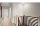 Upstairs hallway features hardwood floors, modern railings, and views into a bright bedroom at 435 Mezzo Ln # 86, Alpharetta, GA 30009