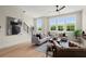 Inviting living room boasts large windows, hardwood floors, and neutral furniture with pops of color at 435 Mezzo Ln # 86, Alpharetta, GA 30009