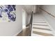 Bright foyer with wooden staircase, light hardwood floors, and modern art piece at 435 Mezzo Ln # 86, Alpharetta, GA 30009