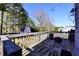 A wooden deck overlooks a large fenced yard and a small structure in the background at 701 Monticello Ln, Mcdonough, GA 30253