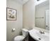 Cozy bathroom with white vanity and sink, mirror, toilet, wall art, and neutral color scheme at 701 Monticello Ln, Mcdonough, GA 30253