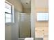 Bright and cozy bathroom with glass door shower, separate bathtub, and window with plenty of light at 701 Monticello Ln, Mcdonough, GA 30253