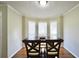 Bright dining area with hardwood floors and natural light streaming through the windows at 701 Monticello Ln, Mcdonough, GA 30253