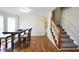 Dining area with hardwood floors, table, chairs, and staircase to the second floor of the home at 701 Monticello Ln, Mcdonough, GA 30253