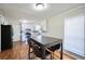 Eat-in kitchen featuring white cabinets, hardwood floors, and stainless steel appliances at 701 Monticello Ln, Mcdonough, GA 30253